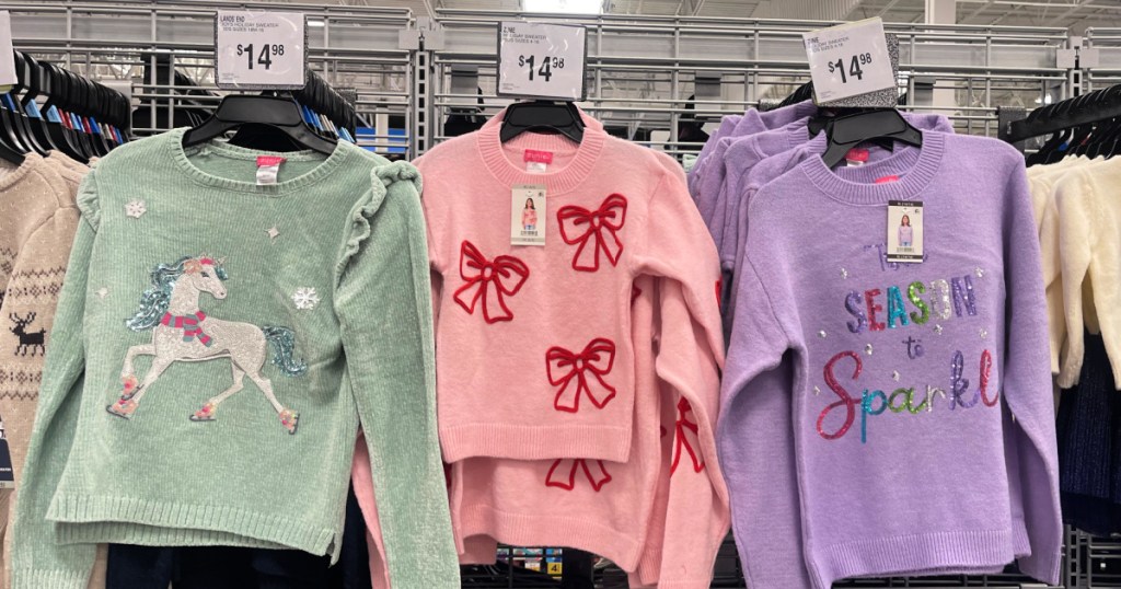 Different colored girls sweaters hanging up inside Sam's Club
