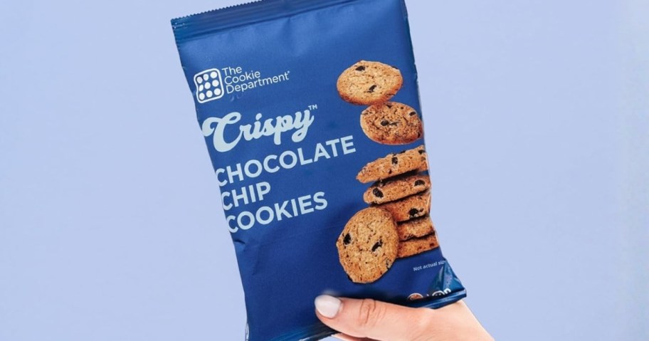hand holding a bag of The Cookie Department Mini Chocoalte Chip Cookies