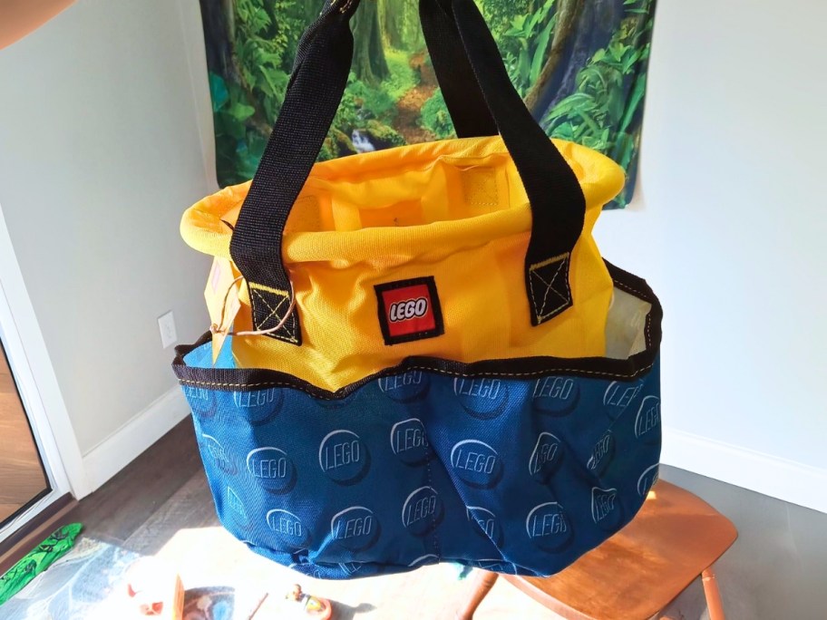 hand holding out a LEGO bucket bag