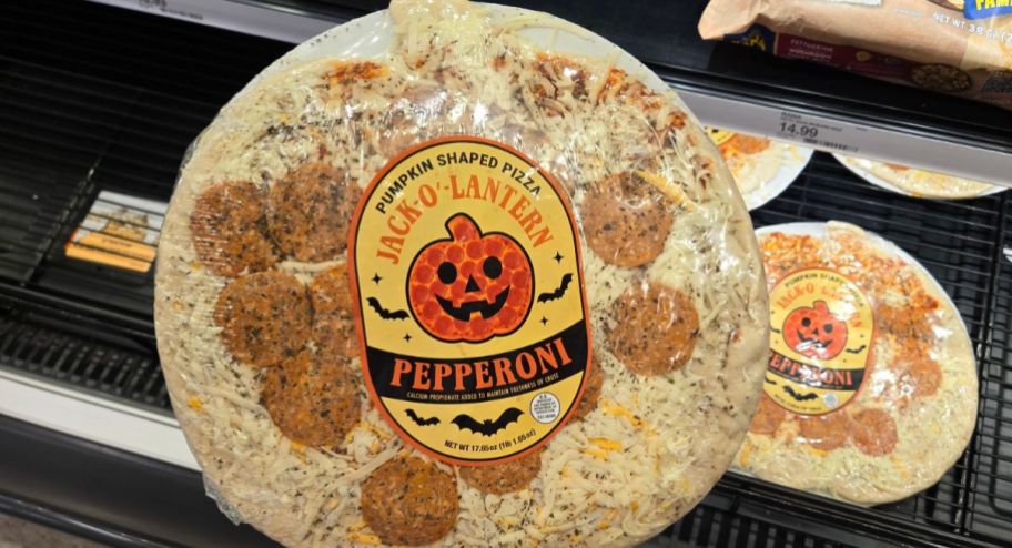 Hand holding halloween pizza