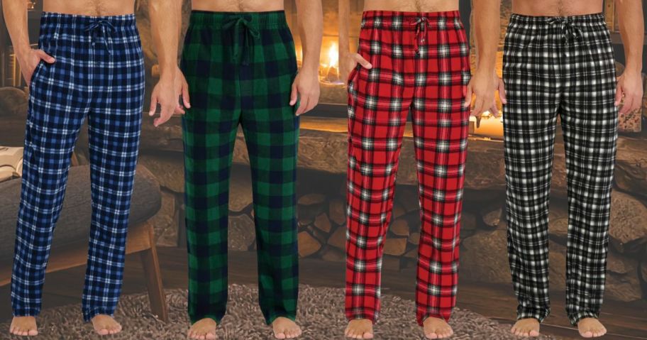 4 men wearing pajama pants in front of a fireplace