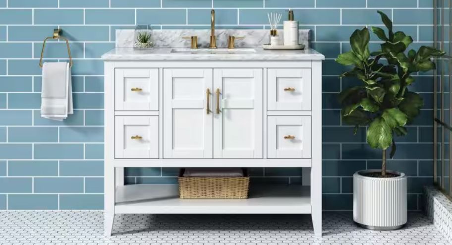 Home depot white vanity with a plant next to it 
