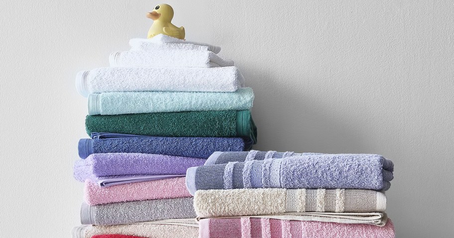 colorful stack of bath towels with a rubber duck on top