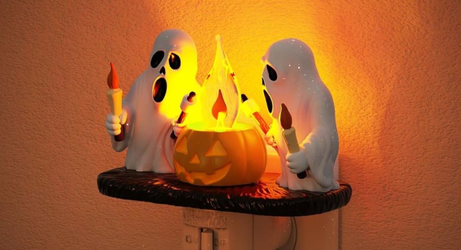 two ghosts with a pumpkin fire plug in