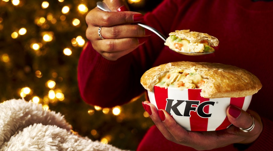 woman holding spoonful of KFC pot pie