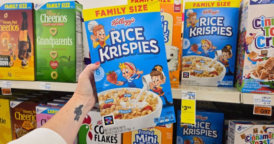 A person holding a Kellogg's Rice Krispies box in a store