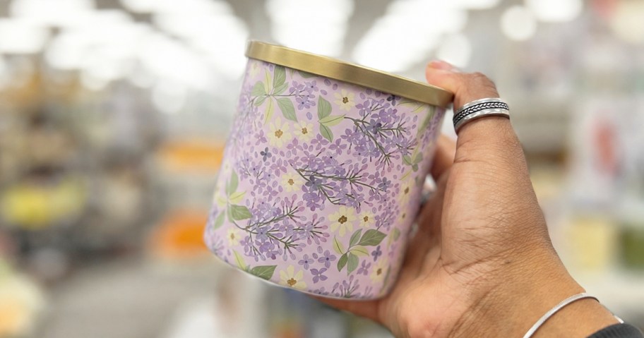 hand holding a purple lilac print jar candle
