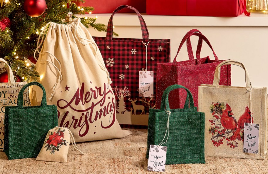 christmas gift bags under a christmas tree