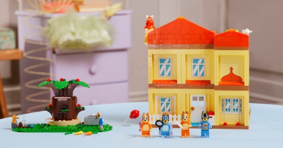 lego bluey family building set set up on table with house, tree, and family figurines 