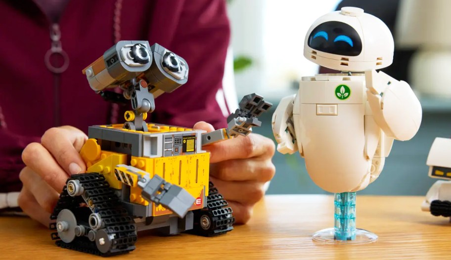 person playing with LEGO Disney and Pixar WALL-E and EVE Building Set