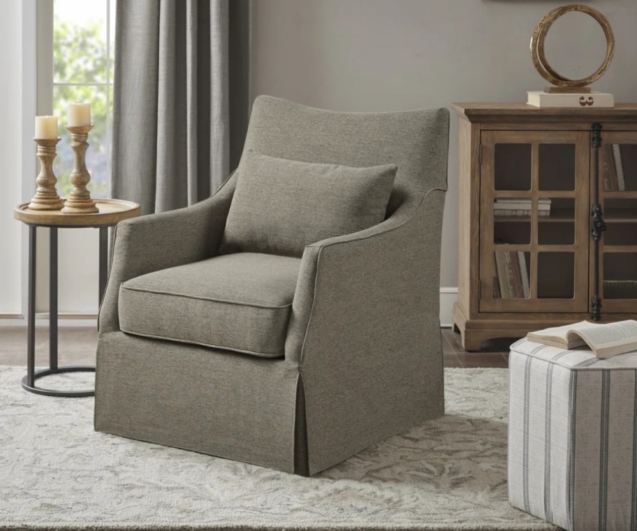 brown swivel chair with lumbar pillow