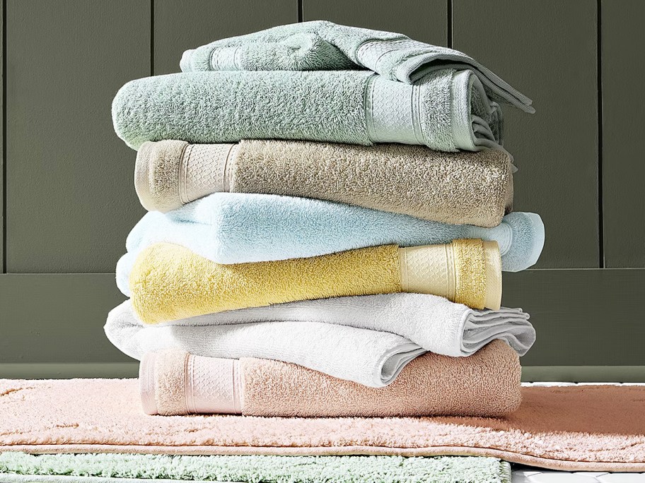 stack of folded bath towels on top of bath mats