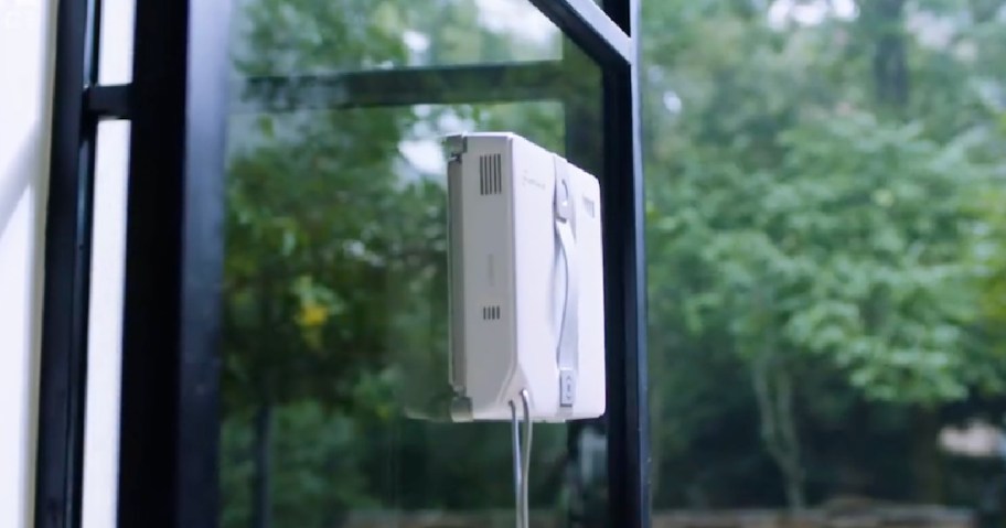 Mini window robot cleaner on glass on outdoor window