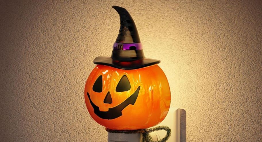 Pumpkin night light displayed on the wall 