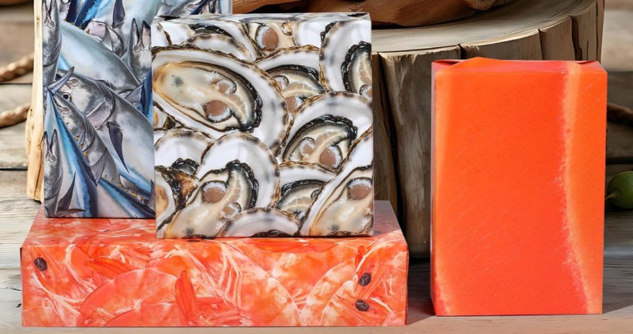 Boxes wrapped in different types of seafood and stacked on table top