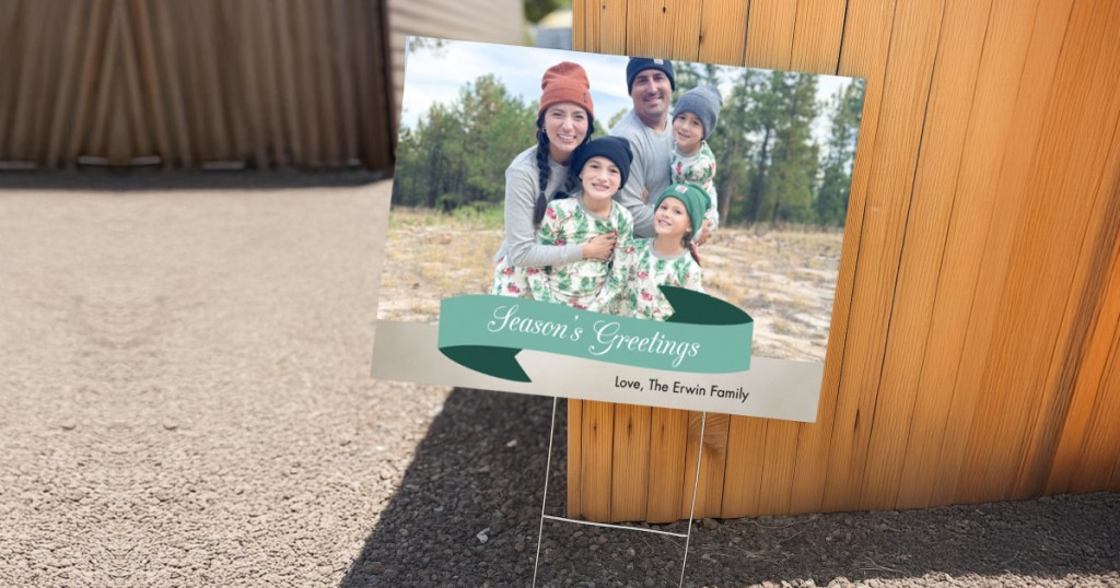 yard sign with family and seasons greetings message