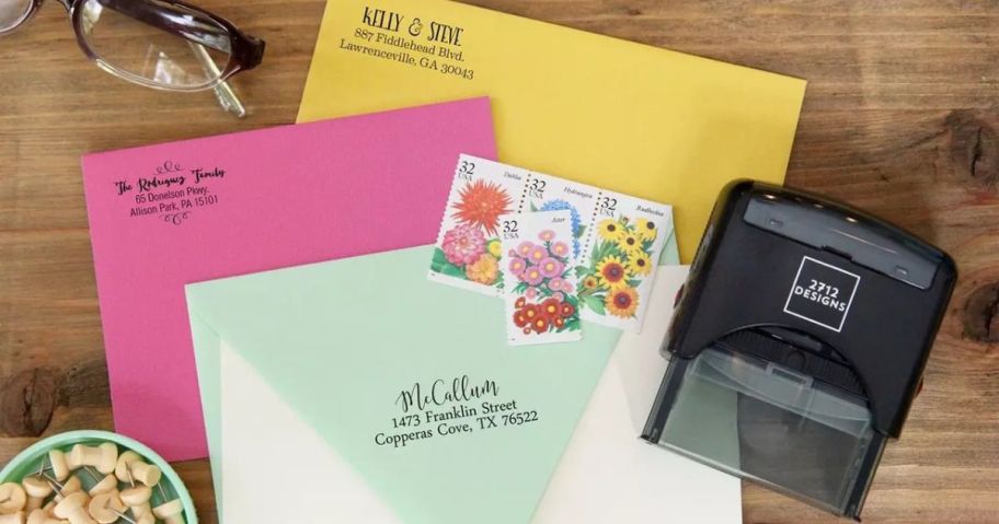 Stamped envelopes next to a 2712 Designs Self-Inking Stamp
