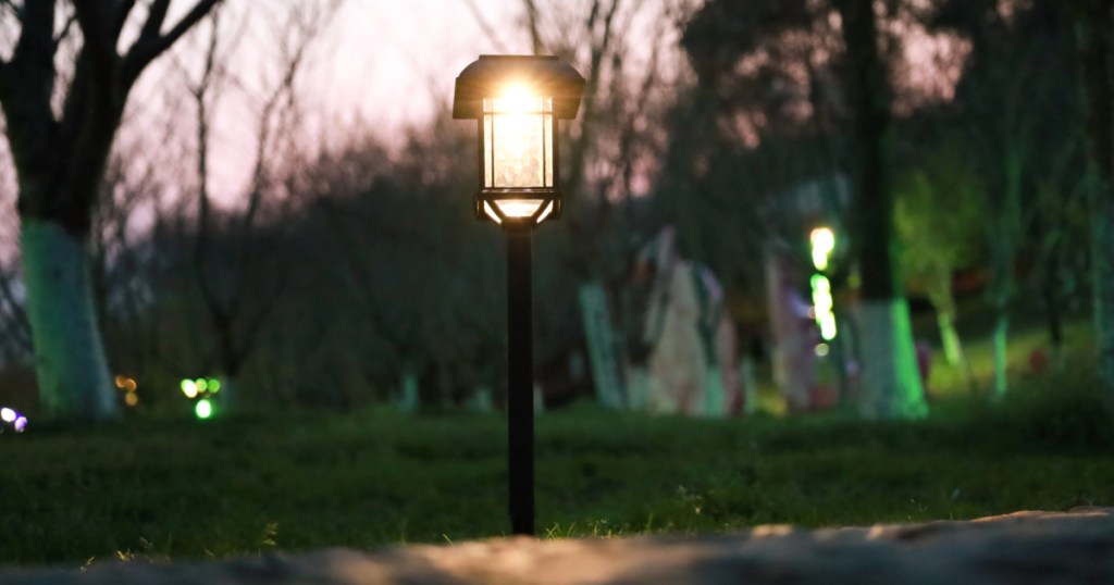 black solar path light next to sidewalk