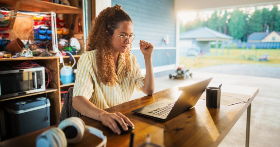 woman sitting at a desk in front of a laptop