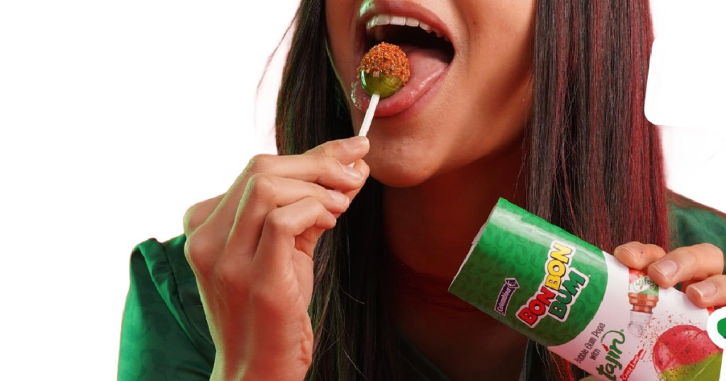 girl licking person holding Bon Bon Bum x Tajín Limited Edition Bubble Gum Lollipop