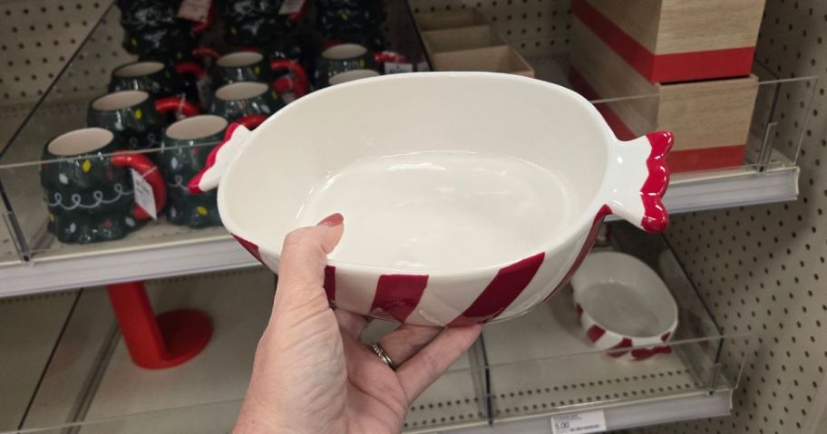 A person holding a bowl in the shape of a mint candy
