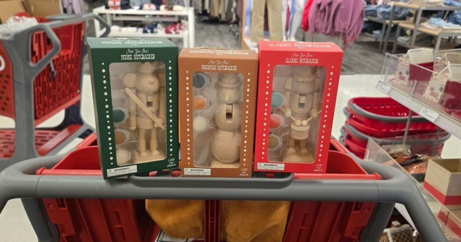 3 paint-your-own nutcracker sets in a cart