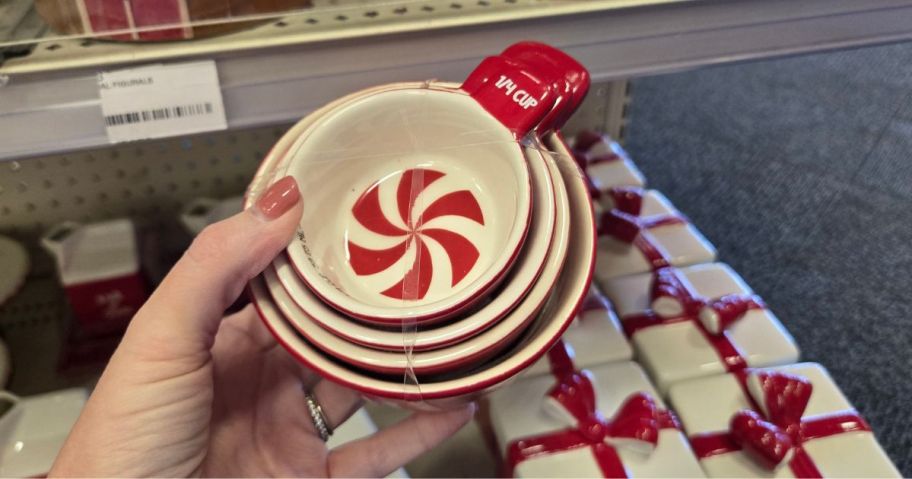 A person holding a set of ceramic measuring cups in the shape of mints