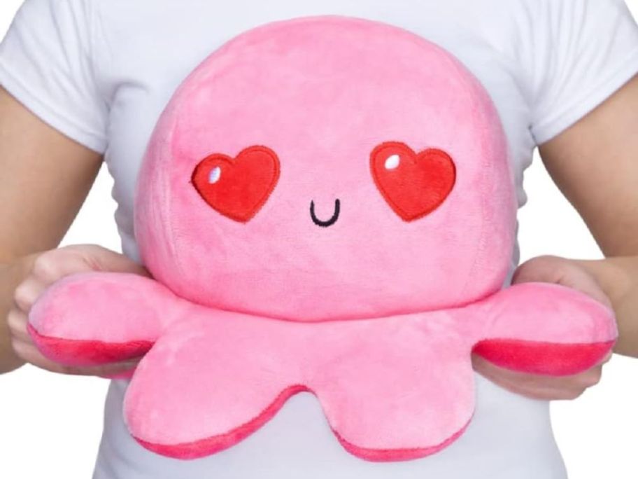 Hands holding a large TeeTurtle Octopus Plush with heart eyes