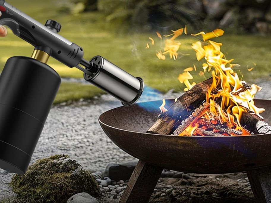 Thermomaven Propane torch being used to light a fire in a fire pit