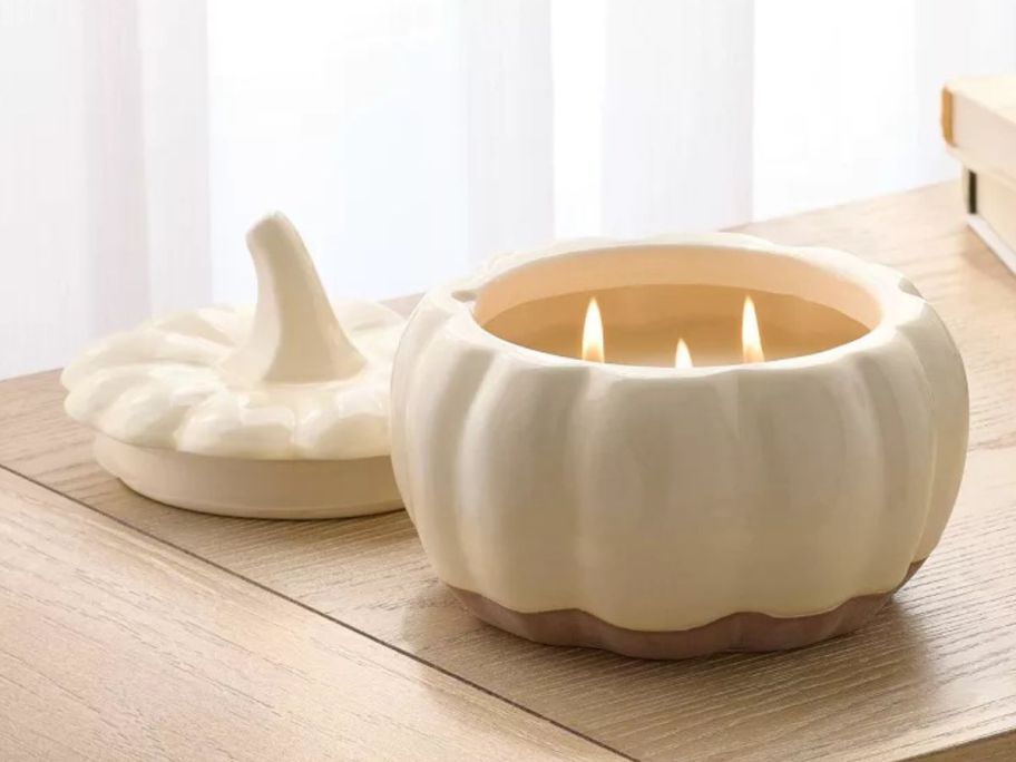 Threshold Pumpkin Jar Candle 18oz lit on table