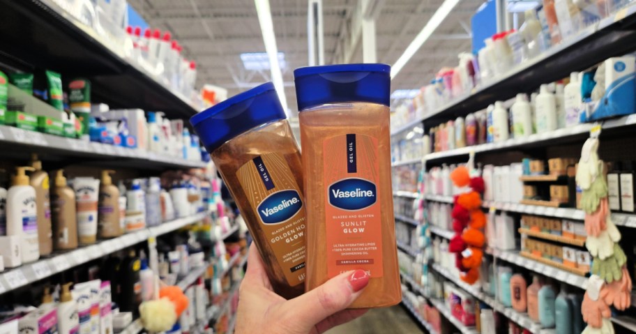 Woman holding two different bottles of Vaseline gel oil while standing in aisle of Walmart store