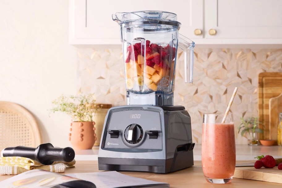 Vitamix Venturist Pro Blender full of fruit next to a smoothie