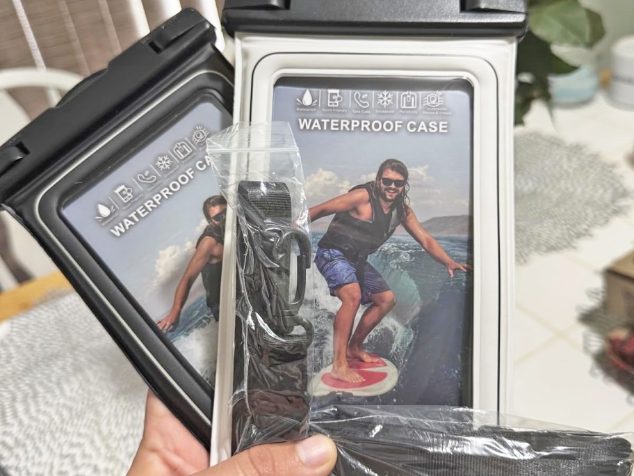 hand holding white and black Waterproof Phone Pouches