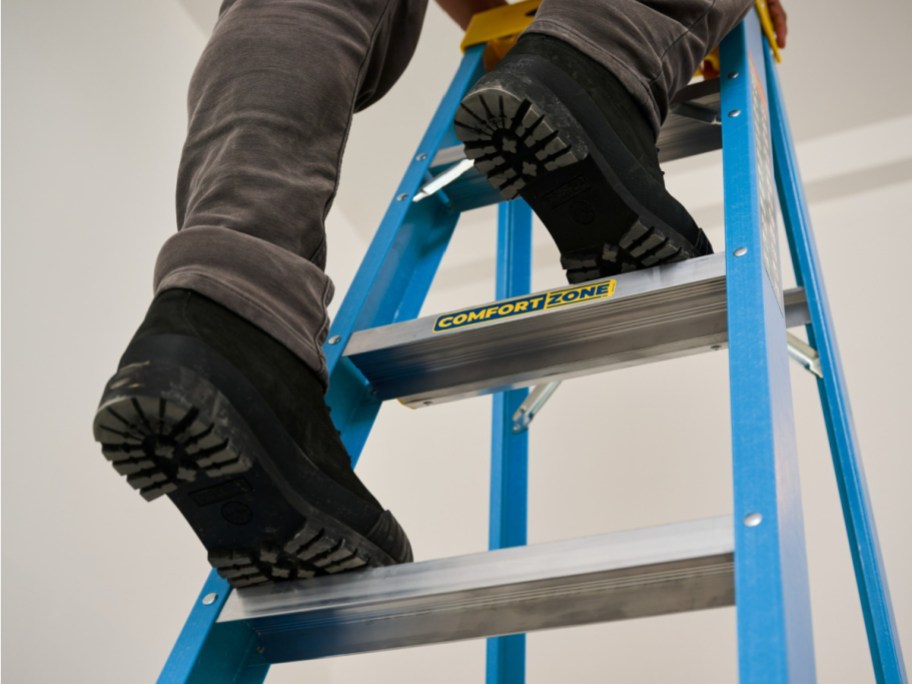 man climbing on werner ladder