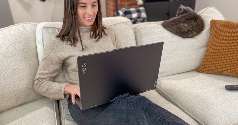 Woman sitting on a couch using a laptop