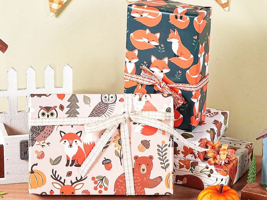 boxes wrapped in fox and owl print wrapping paper
