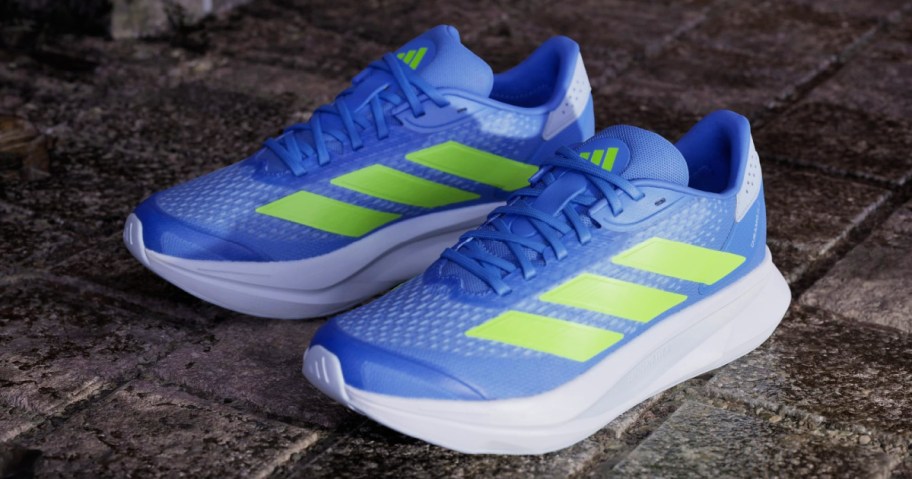 purple and green adidas sneakers