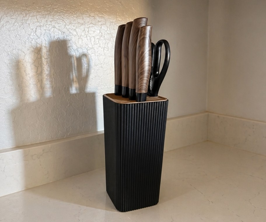 black astercook knife set with block displayed on a kitchen counter