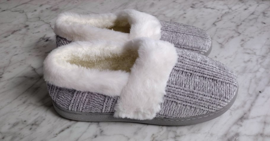 a pair of gray knit closed toe slippers
