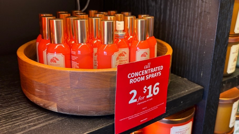 a bowl of room sprays on a shelf in a store