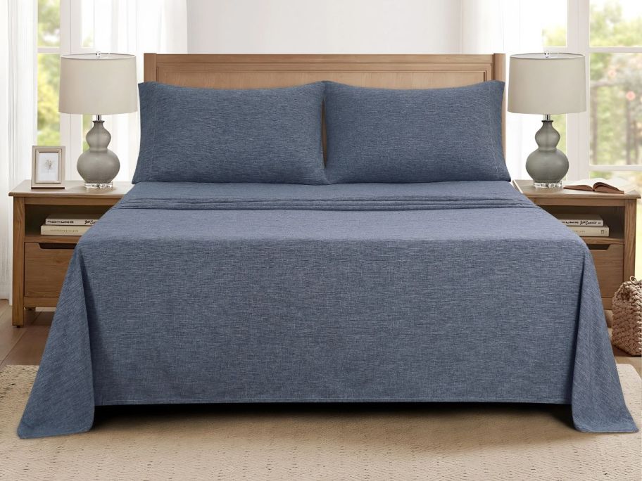 navy bedding set on bed in bedroom