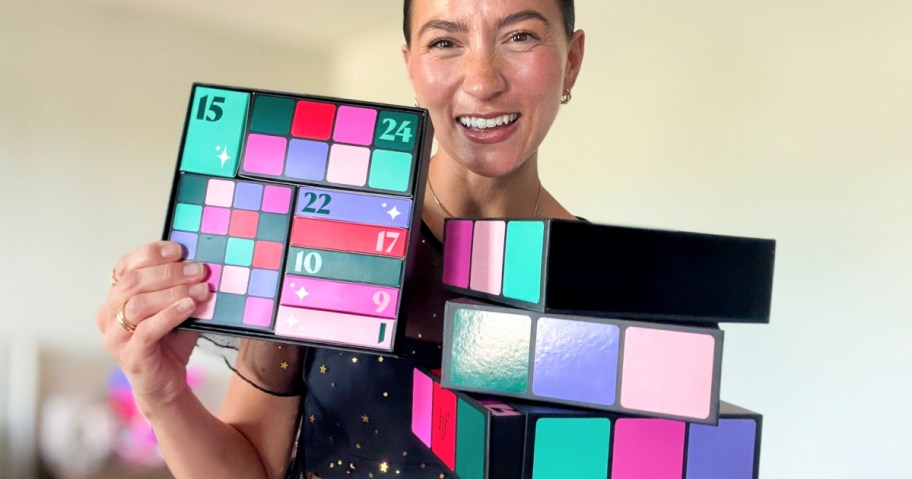 woman holding up a benefit glam cube advent puzzle box