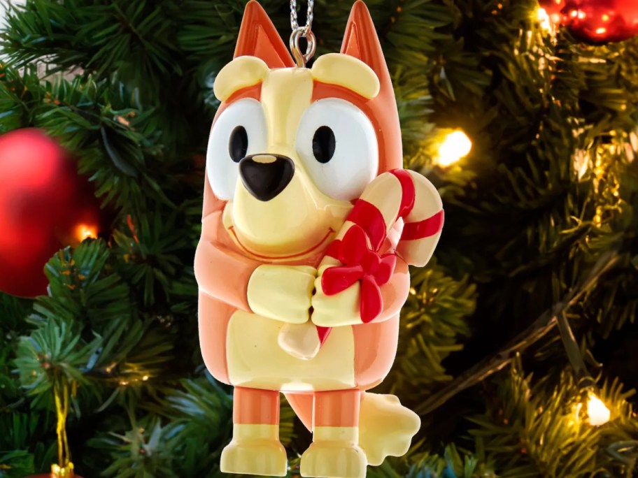 A Bluey Bingo ornament hanging in a tree.