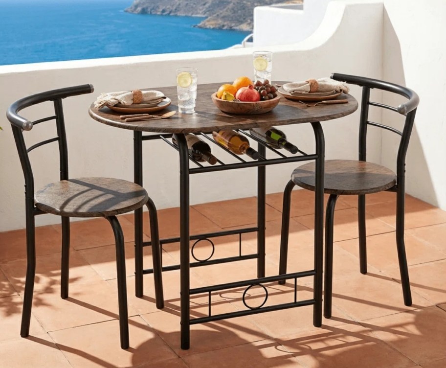 three piece bistro set on a balcony