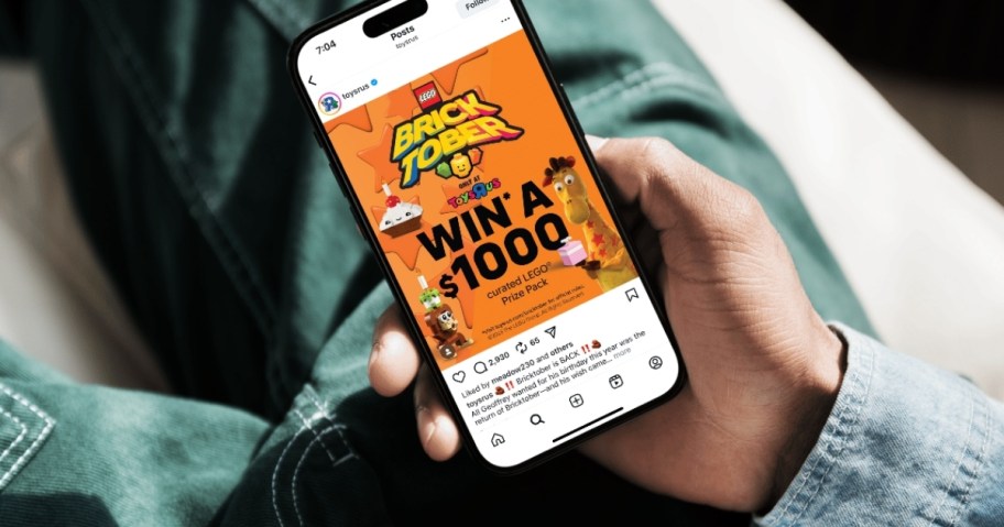 man holding a phone with lego bricktober and toys r us sweepstakes