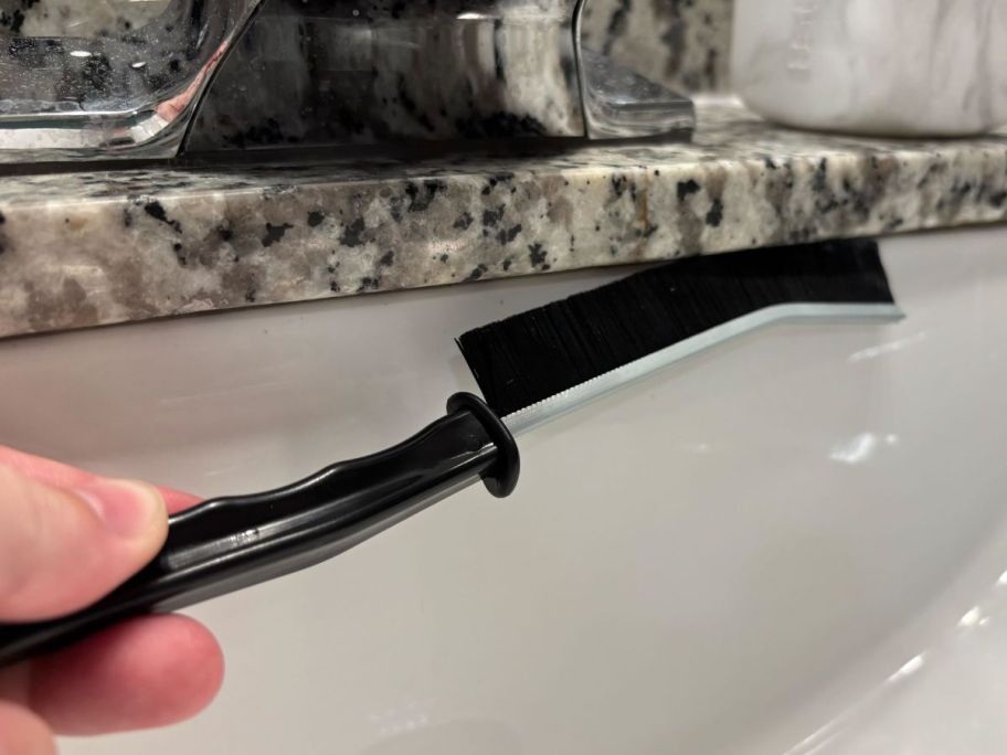 gap cleaning brush in sink crevice