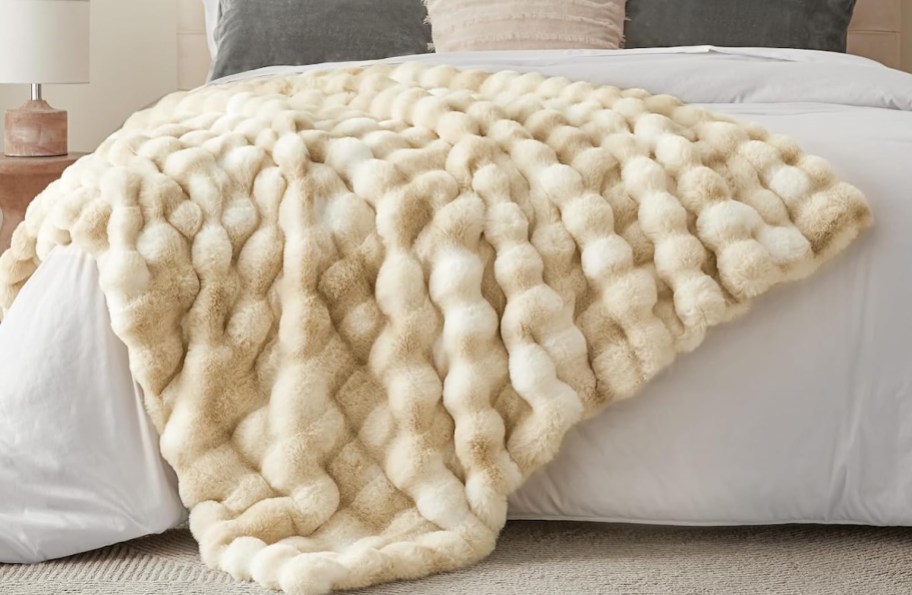 cream colored bubble blanket on bed
