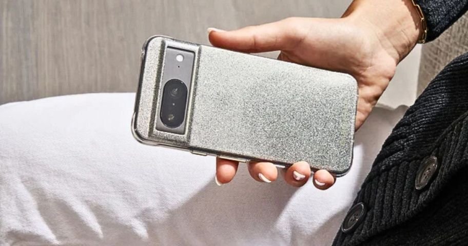 person holding phone with glittery case