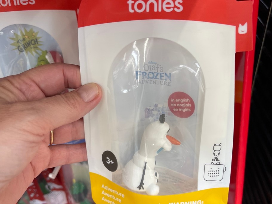 hand holding a package with an Olaf Tonies figure