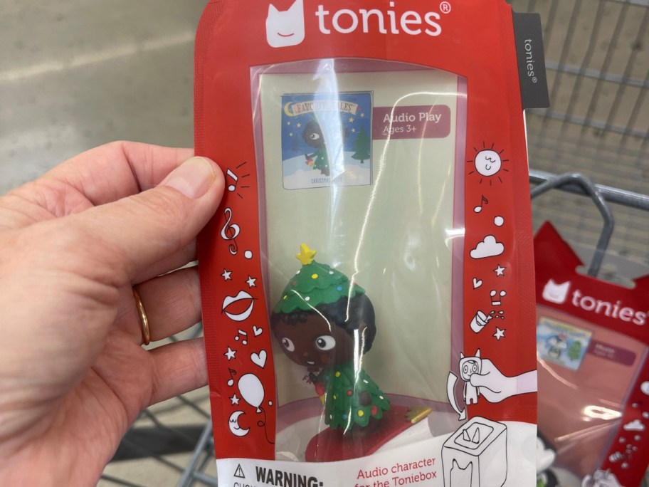 hand holding a package with a Tonies Christmas elf figure